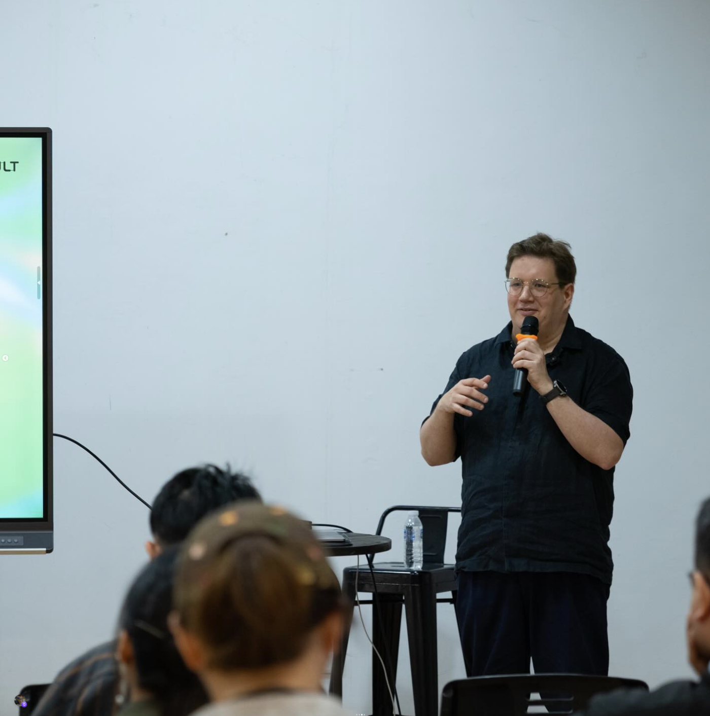 Jussi Koitela is presenting in front of an audience.