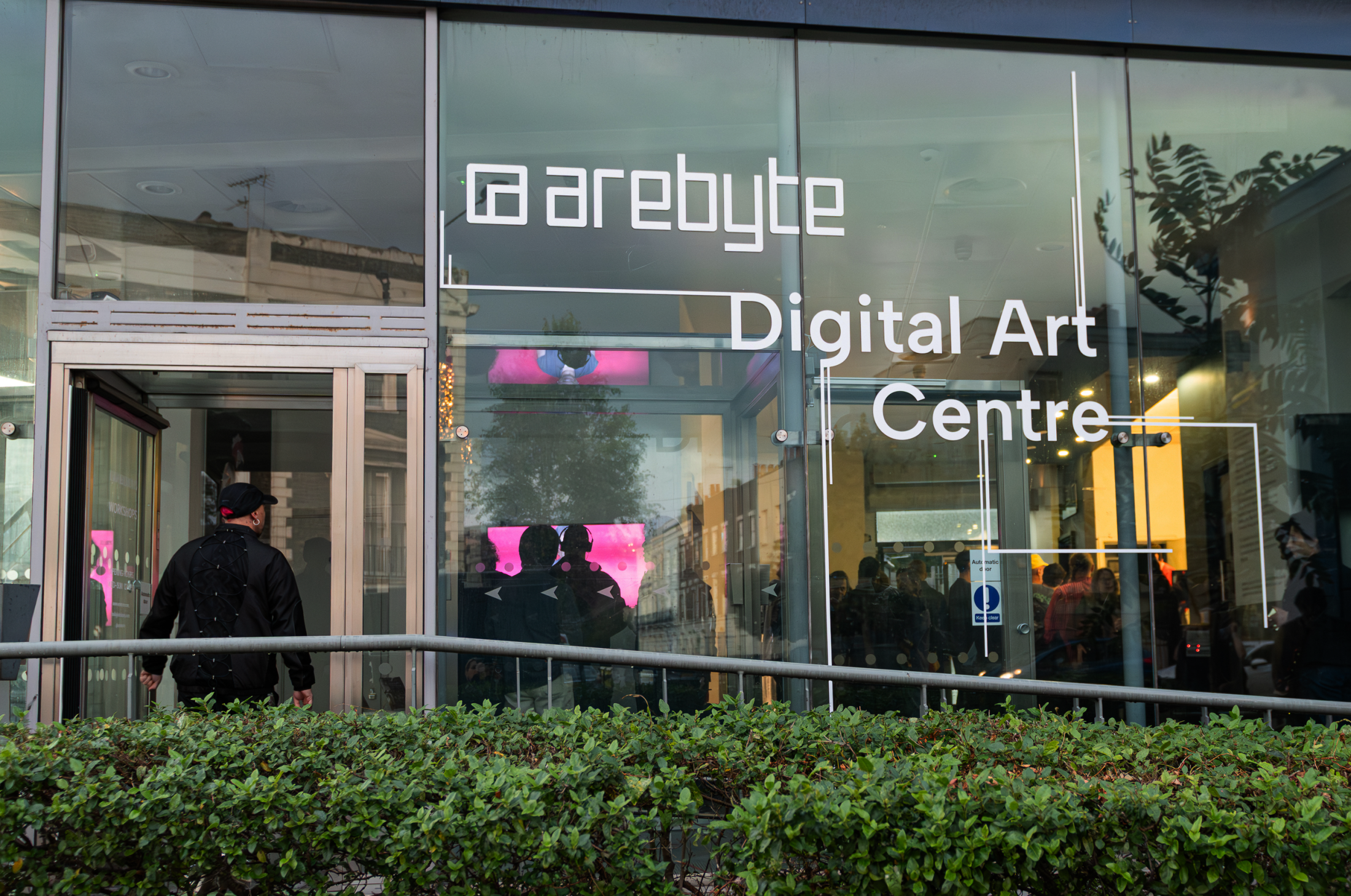 Arebyte Digital Art Centre London, front-entrance. Glass window and bushes in the front.