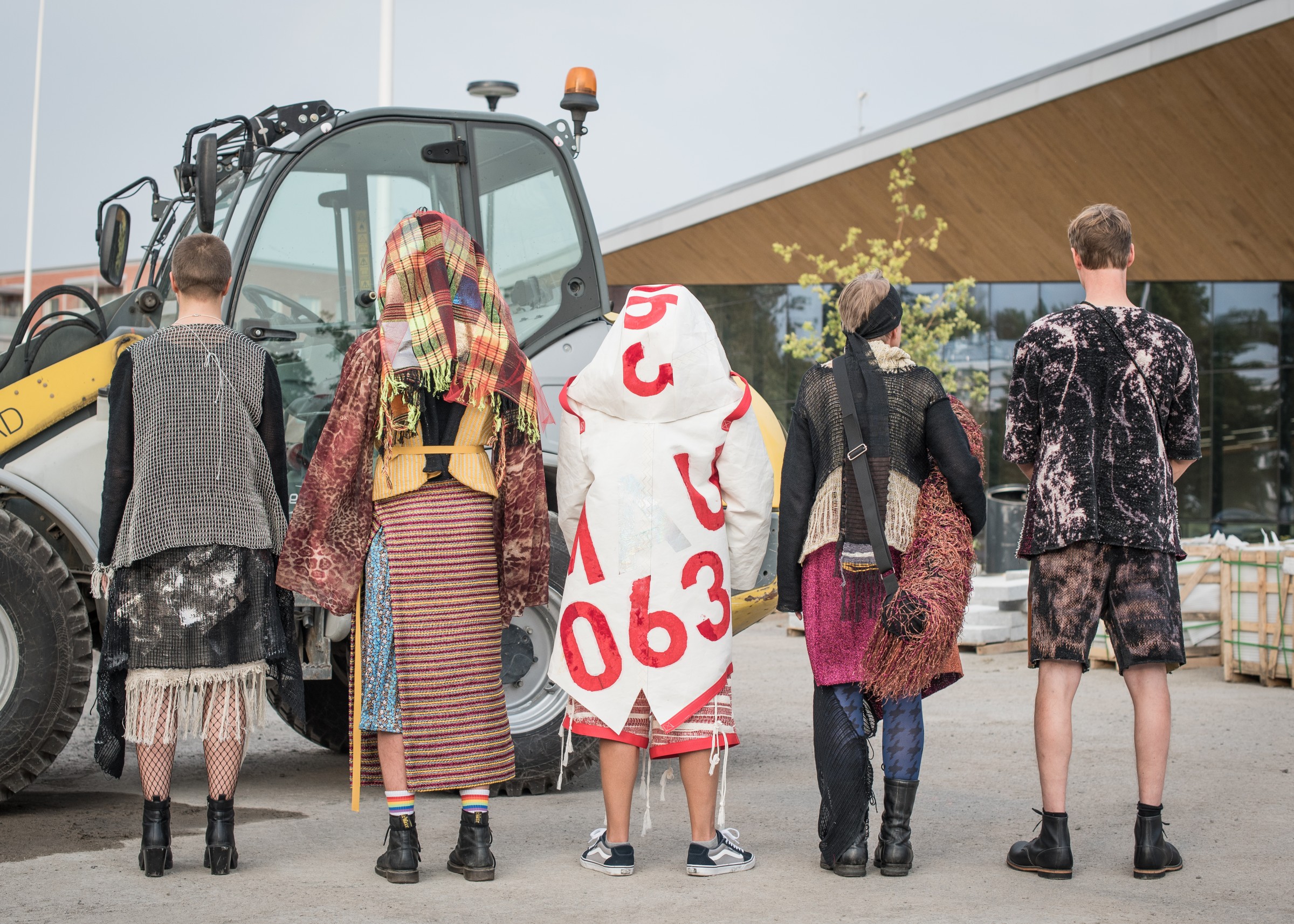 Five models standing back to the camera