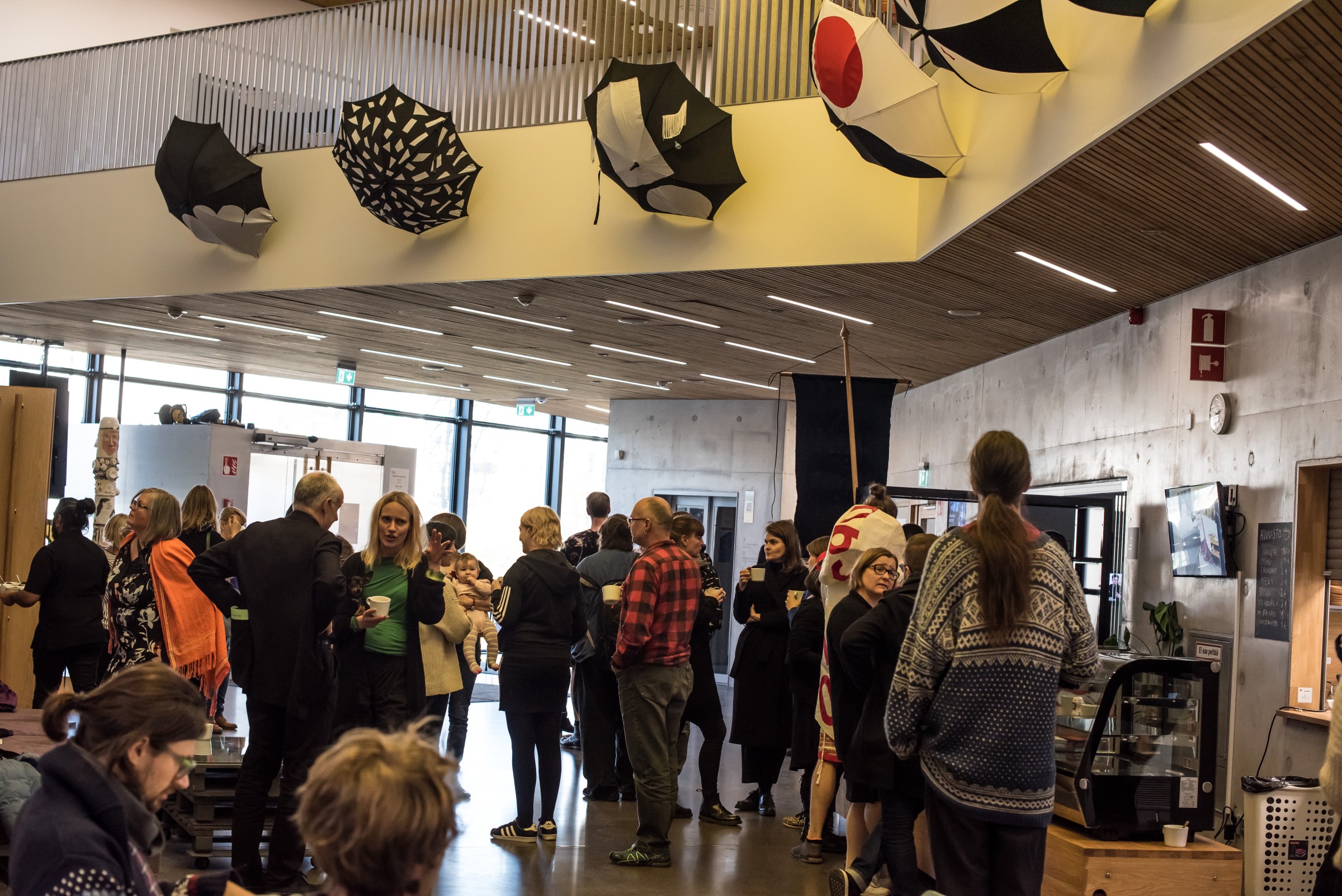 Many people mingling in a lounge, having a break