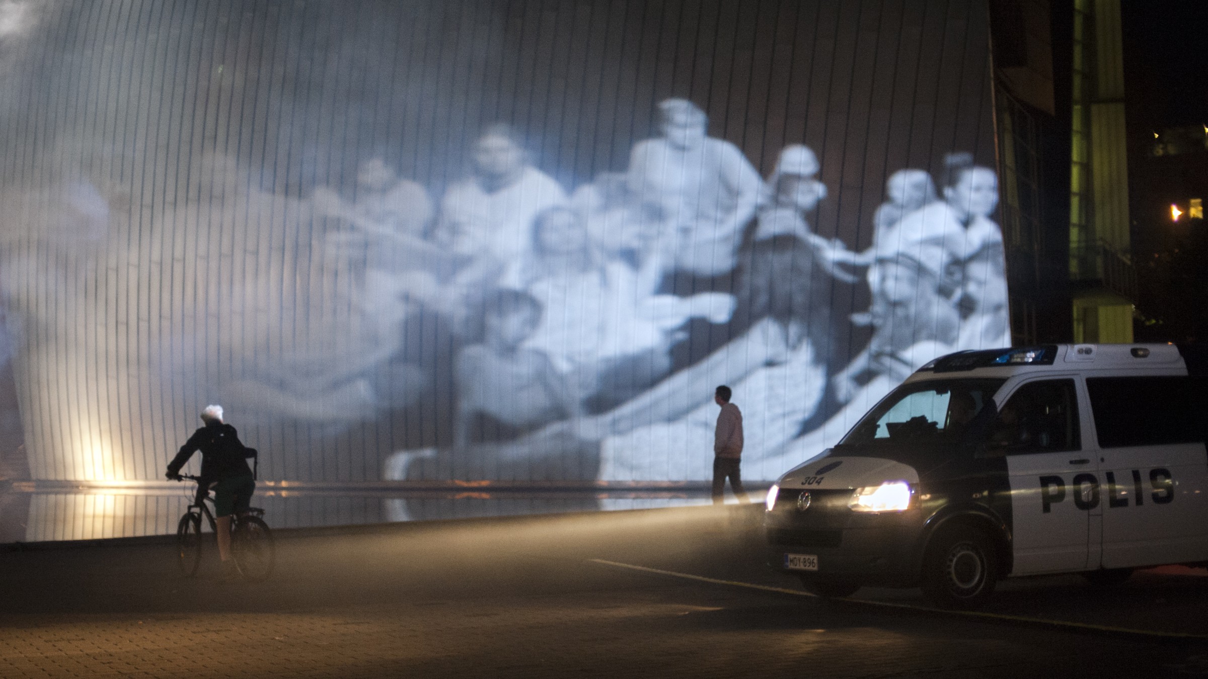Spectre of People projection with police van